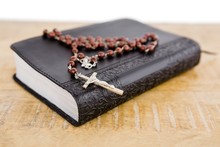Close-up Of Bible And Rosary Beads