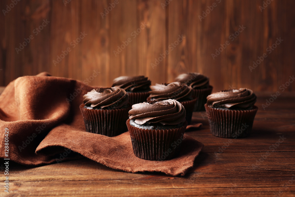 Tasty cupcakes on wooden table