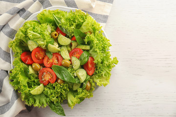 Wall Mural - Tasty vegetable salad on kitchen table