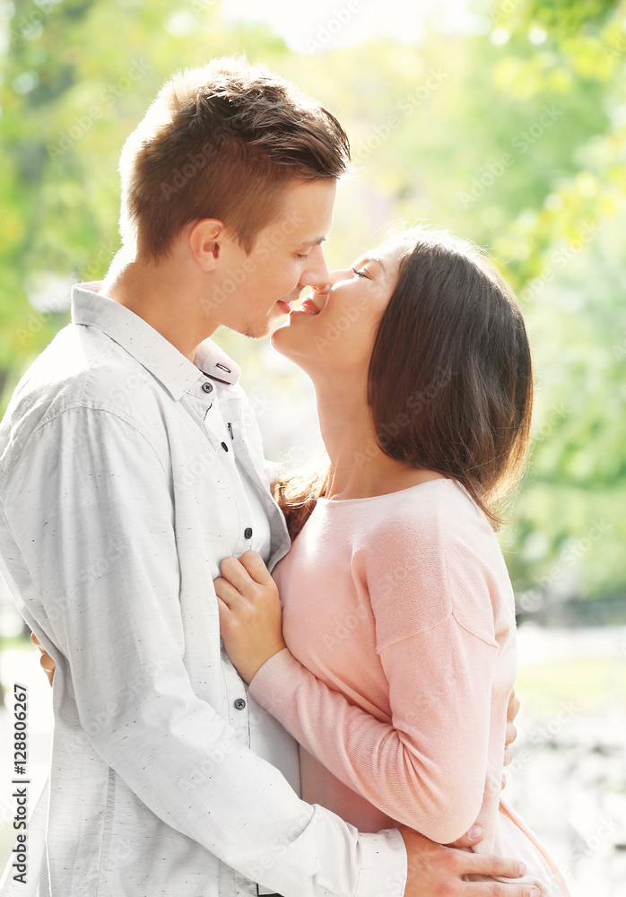 Beautiful young couple outdoors on blurred background