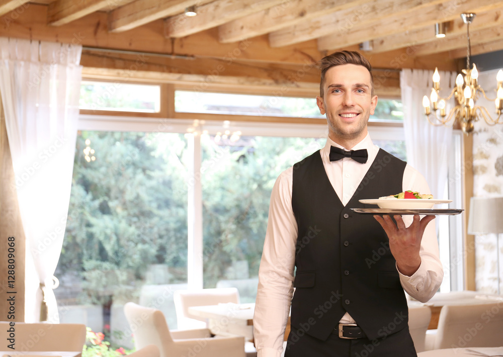 Handsome young waiter at restaurant
