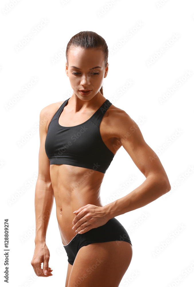 Sporty young woman posing isolated on white