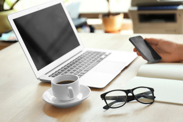 Poster - Businessman working place with laptop, glasses and cup of coffee