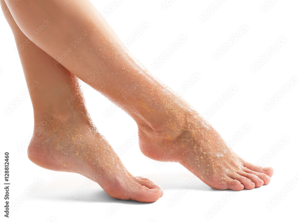 Female feet with scrub isolated on white