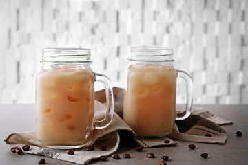 Wall Mural - Iced coffee with milk in jars on napkin