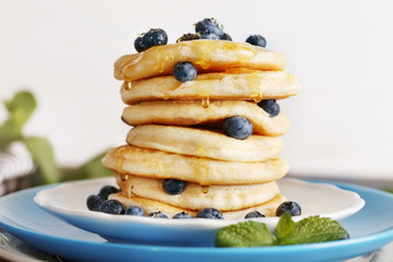 Wall Mural - Tasty pancakes with blueberry on plate