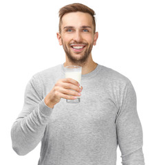 Wall Mural - Young man with glass of fresh milk on white background