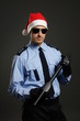 © petrdlouhy - Young policeman as santa claus on gray background