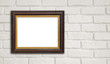 © didecs - Brown vintage picture frame on white brick wall with copyspace