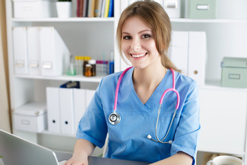 Female doctor working at her office