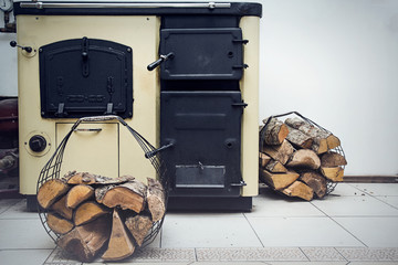 Russian stove with firewood baskets in the kitchen. With that kind of stove can to heat the room and also on the stove can to cook meal.