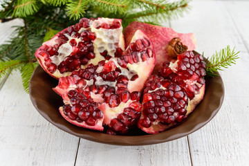 Wall Mural - Ripe garnet have broken into pieces on a white background. Juicy Asian fruit. Close up.