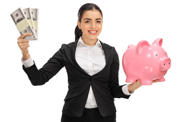 Canvas Print - Delighted businesswoman holding money bundles and piggybank