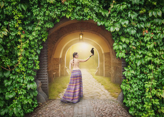 Wall Mural - Beautiful woman with crow on the mysterious sunny road