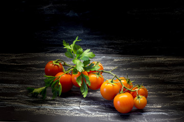 Cherry tomatoes and  parsley on black background.Healthy eating, vegetarian concept. Organic food.