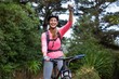 Athletic woman standing with mountain bike