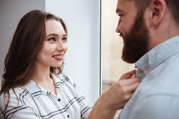 Poster - Loving couple standing near window together