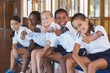 © WavebreakMediaMicro - Portrait of school kids showing thumbs up in basketball court