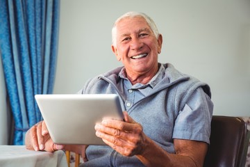 Wall Mural - senior man using a digital tablet