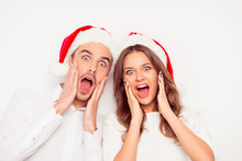 Wow! Portrait Of Two Shocked Amased Excited Lovers In Red  Santa