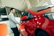 © NDABCREATIVITY - Customer buying car at dealership