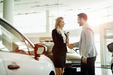 Salesperson workin at car dealership