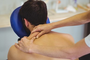 Wall Mural - Physiotherapist giving back massage to a patient