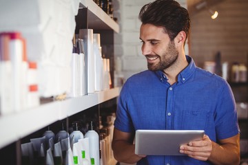 Male hairdresser using digital tablet