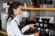 © WavebreakmediaMicro - Smiling waitress making cup of coffee