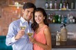 © WavebreakmediaMicro - Portrait of young couple holding glass of wine