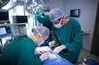 © Wavebreak Media - Surgeons performing operation in operation theater