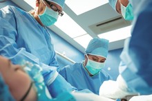 Team Of Surgeons Performing Operation In Operation Theater