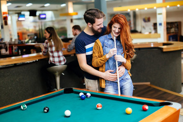 Wall Mural - Couple spending time together by playing pool