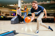 © NDABCREATIVITY - Friends having fun while bowling