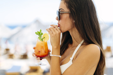 Wall Mural - Attractive woman holding cocktail