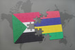 puzzle with the national flag of sudan and mauritius on a world map