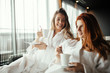 © NDABCREATIVITY - Women relaxing and drinking tea
