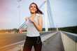 © NDABCREATIVITY - Sporty woman jogging outdoors