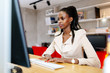 © NDABCREATIVITY - Black businesswoman using computer