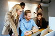 © NDABCREATIVITY - Business people collaborate in office