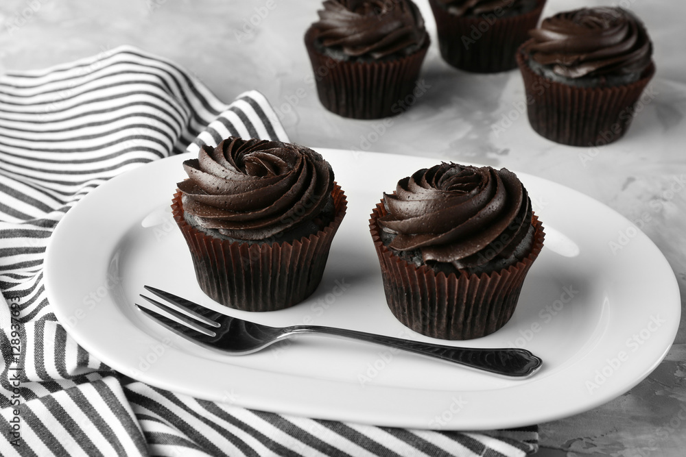 Tasty cupcakes on plate