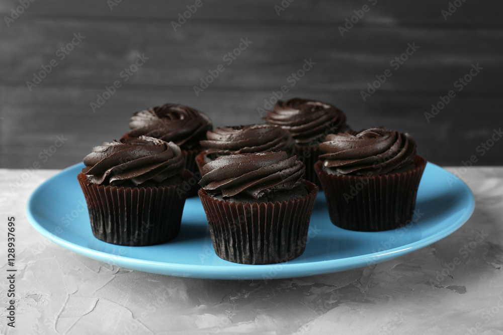 Tasty cupcakes on blue plate