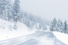 Beautiful Winter Scene With Icy Slick Road Driving Situation Curving Road Covered With Snow And Snowy Trees All Around