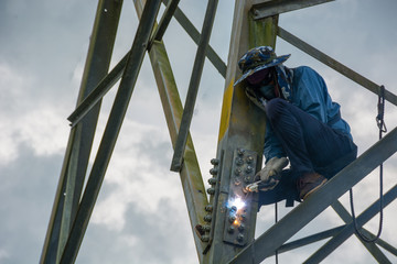 Welder work at high Electric high voltage pole 230 Kv