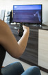 © Degimages - Woman hold TV remote control. Watching televion in room.