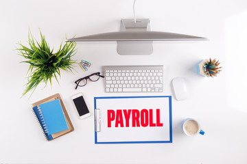 Office desk with PAYROLL paperwork and other objects around, top