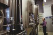 Owner examining machinery at brewery