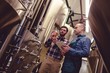 © WavebreakMediaMicro - Worker and owner discussing over beer in container