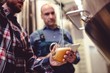 © WavebreakMediaMicro - Owner pouring beer in glass at brewery