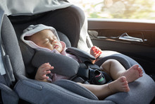Close Up Asian Cute Newborn Baby Sleeping In Modern Car Seat.